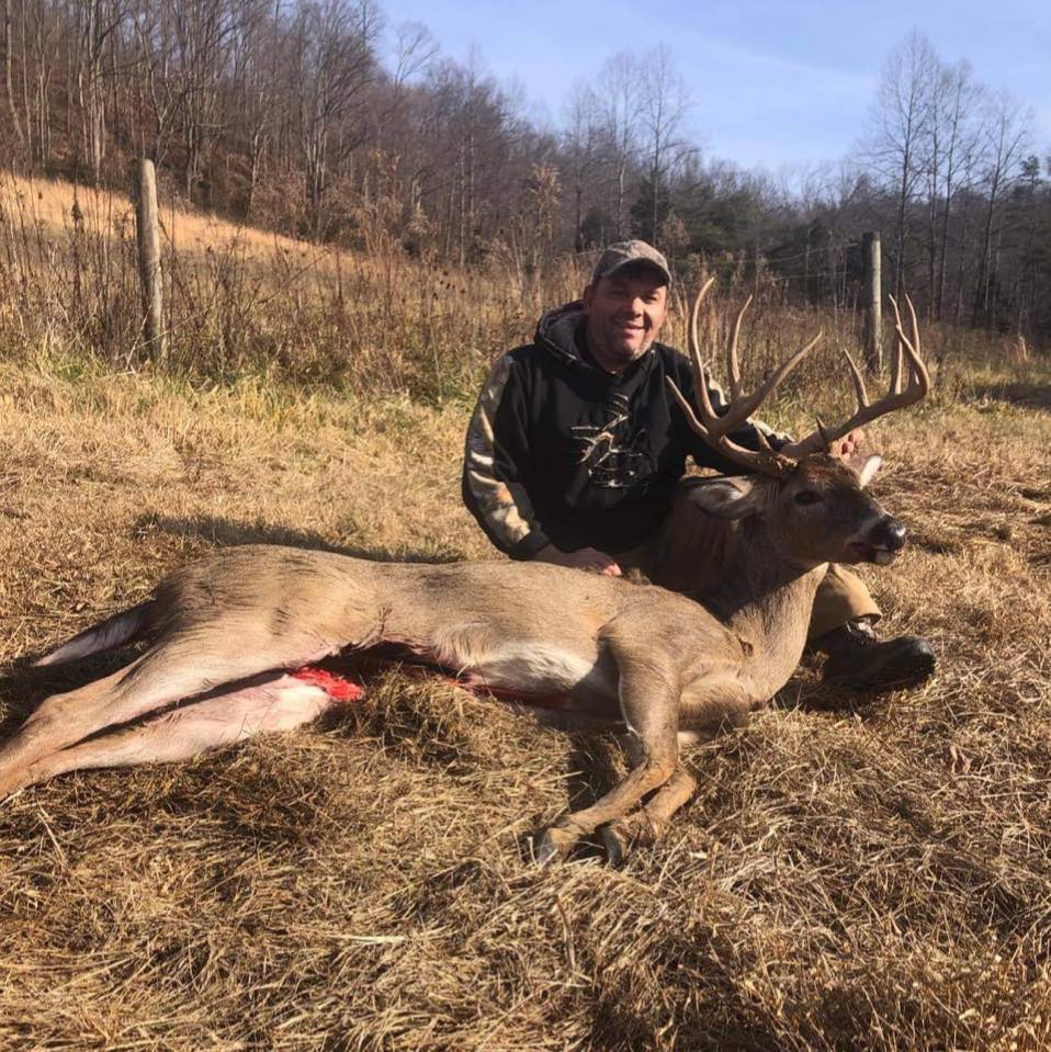 Hunter poses with a large buck harvested in Kentucky.