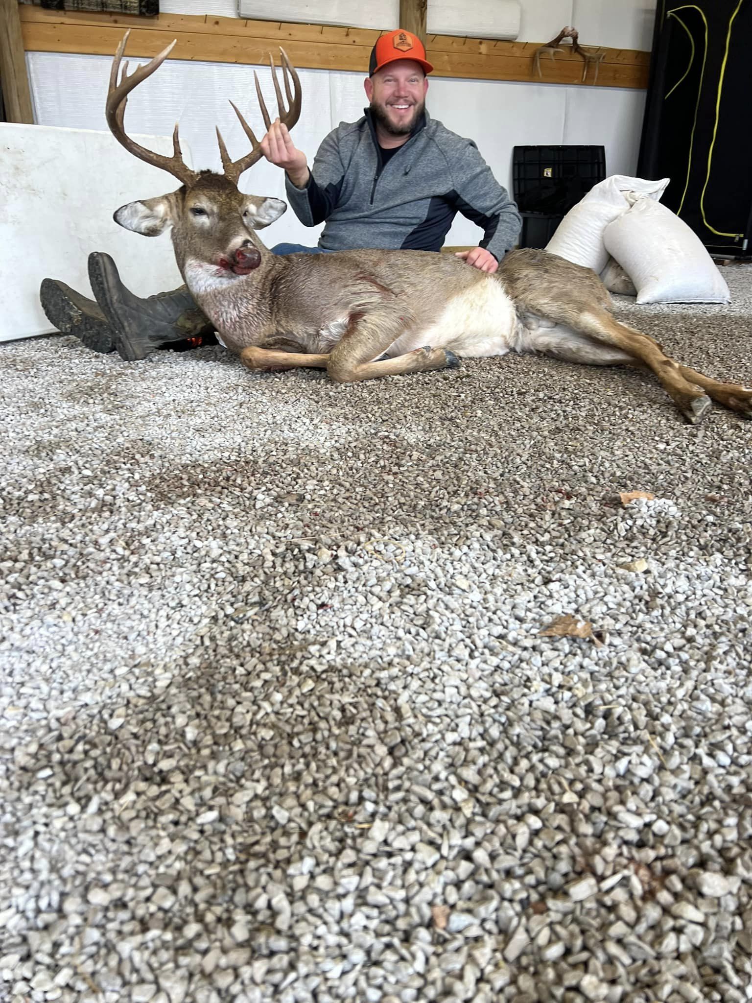 Hunter proudly displays a large buck harvested during Kentucky whitetail season.
