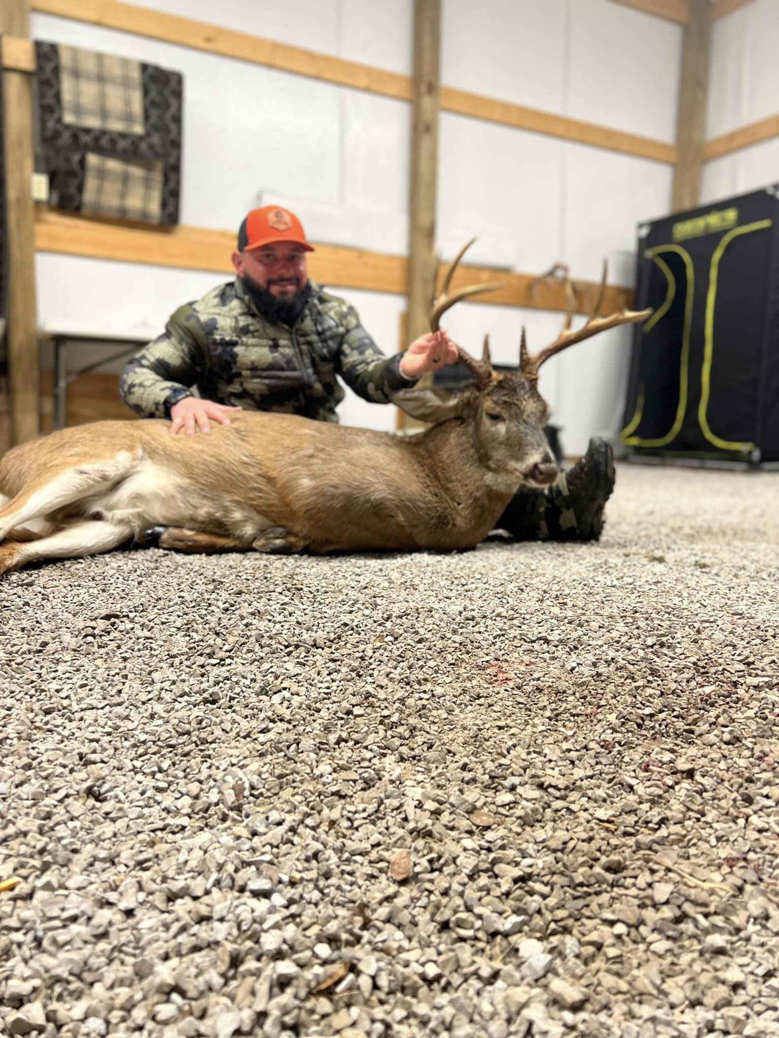 Hunter posing behind a large buck harvested in Kentucky.