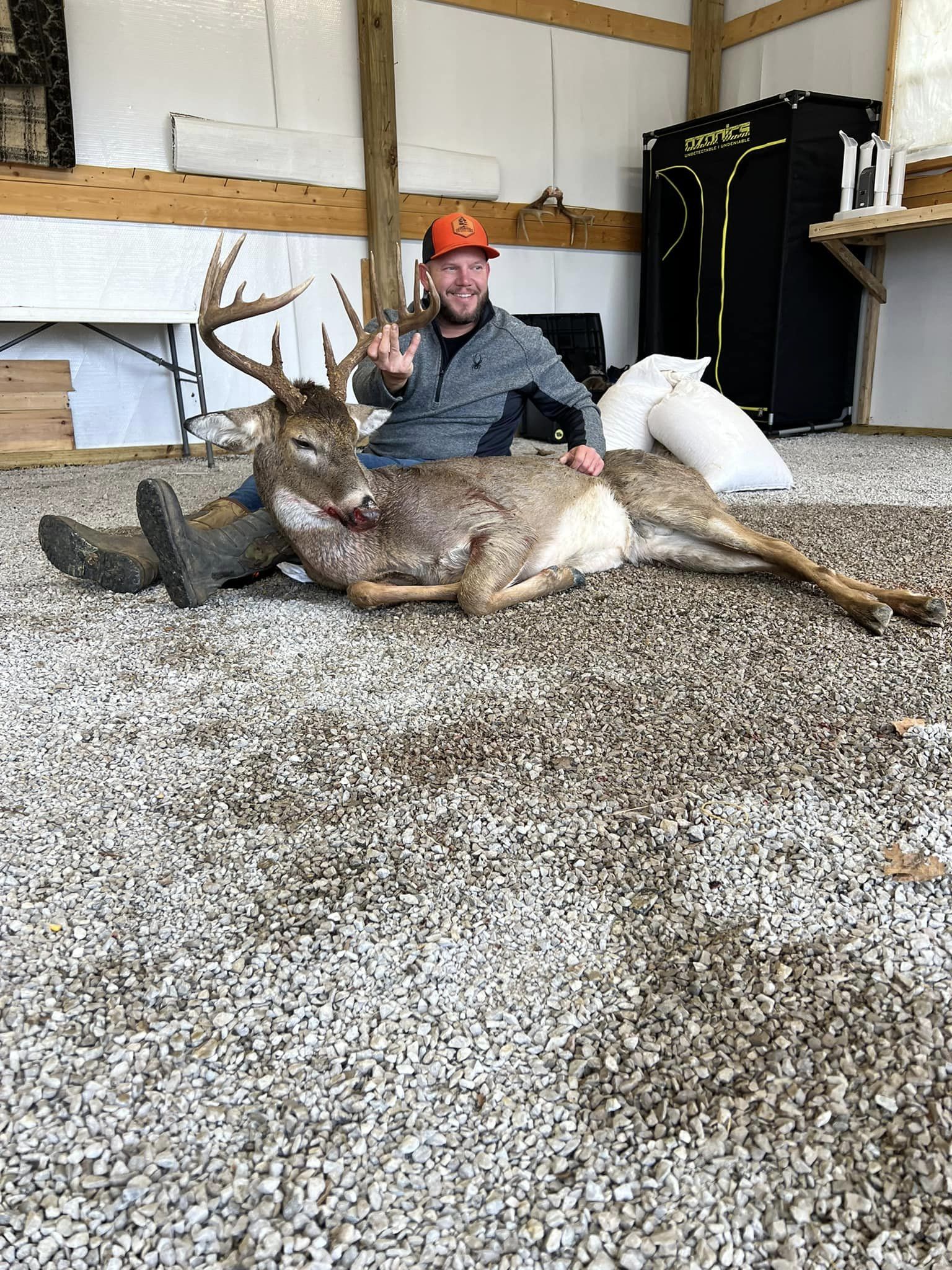 Hunter displays a mature buck harvested on rolling Kentucky hardwood ridges.