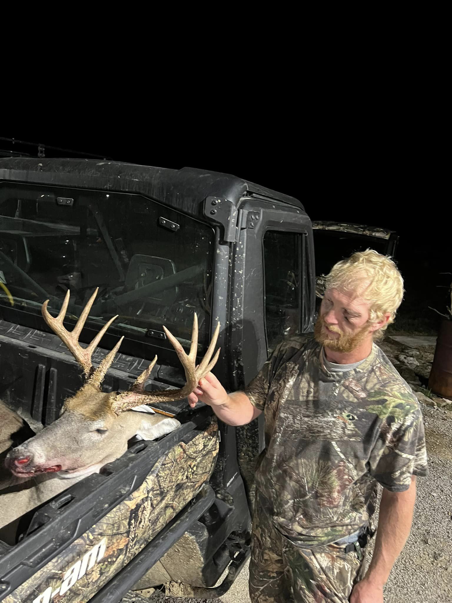 A hunter displays a mature buck harvested on the property.